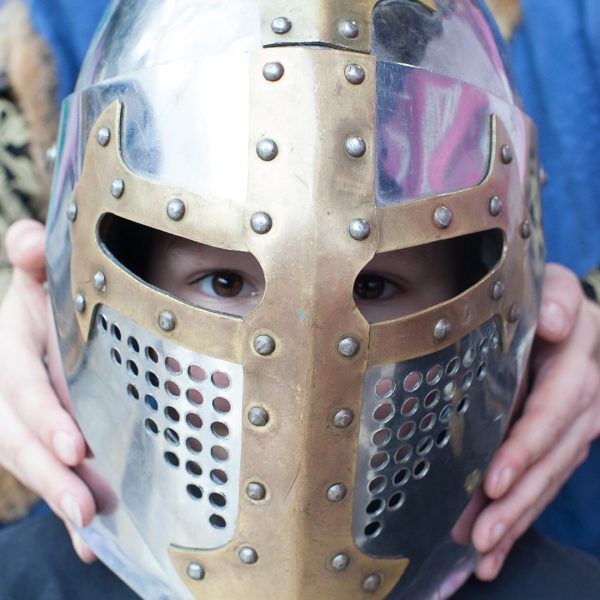 Child wearing a soldiers helmet at shopping centre event