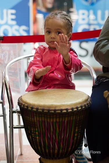 Child playing drum at a shopping centre event 2