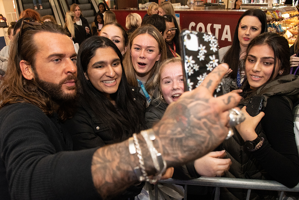celebrity taking a selfie with fans