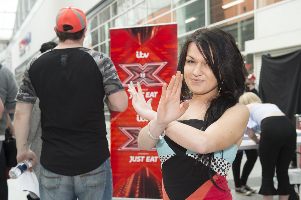 Woman crossing arms at X Factor event