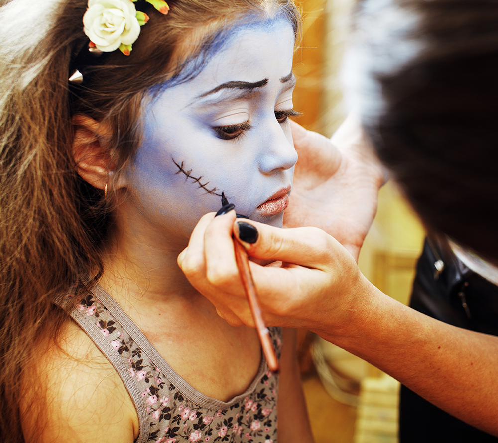 little cute child at facepainting birthday party