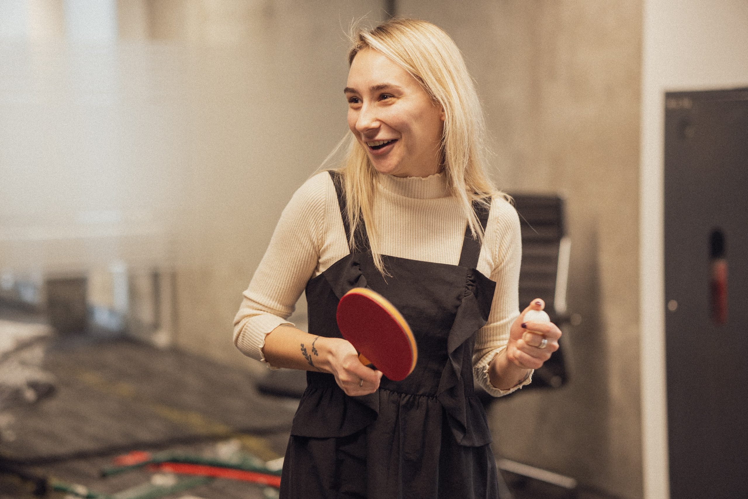 Happy woman playing ping pong