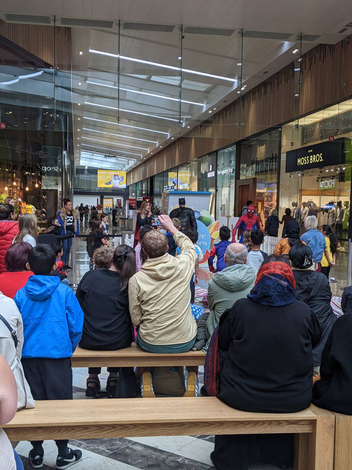 shopping centre interior batman costume event